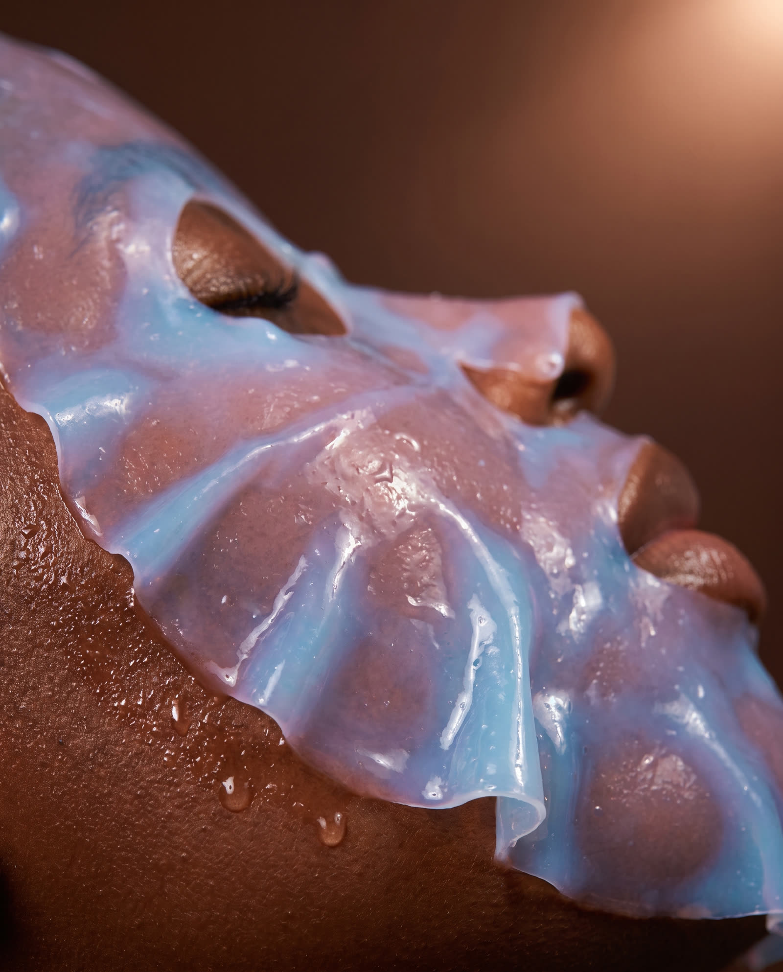 A translucent jelly mask settling on glowing skin