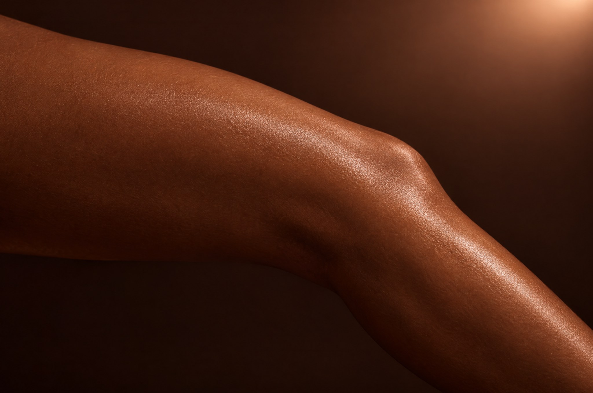 A smooth leg with a satin sheen in warm light, the Full Leg Wax at Glo Haus by Alanii, Orlando